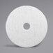 A white circular 3M floor pad.