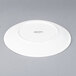A white Arcoroc porcelain brunch plate with a circular design.