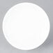 An Arcoroc white porcelain B&B plate with a white rim on a gray surface.