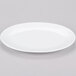 A white Chef & Sommelier bone china oval platter on a gray surface.