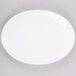 A white Chef & Sommelier oval platter on a gray surface.