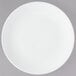 A white Chef & Sommelier bone china plate with a white rim on a gray surface.