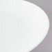 A close-up of a Chef & Sommelier white bone china plate with a white rim.