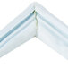 The white and blue corner of a white vinyl magnetic door gasket.