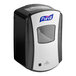 A black and silver Purell LTX-7 touchless hand sanitizer dispenser in a box with a clear window.