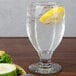 A Libbey Chivalry banquet goblet with a lemon wedge in a glass of water.