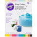 A box of Wilton gel food coloring in blue, white, and yellow containers.