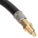 A black and gold rubber gas connector hose with brass fittings.