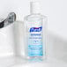 A bottle of Purell Advanced hand sanitizer on a counter.