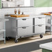 A stainless steel four-drawer worktop freezer on wheels, designed for commercial kitchen use.