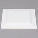 A white square plastic plate with a gold square border.