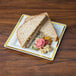 A Fineline Silver Splendor plastic square plate with a sandwich on it, with a side of vegetables.