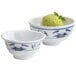 Two white melamine bowls, one with a blue water lily design, filled with green ice cream.