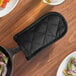 A black quilted cotton pot or pan handle cover.