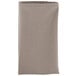 A folded beige Intedge cloth napkin.