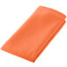 A folded orange Intedge cloth napkin.