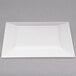 A white rectangular plastic plate with gold bands.