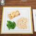A Fineline Silver Splendor plastic square plate with rice, peas, and a lemon slice on it.