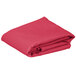 A folded hot pink rectangular table cover.