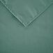 A seafoam green  Intedge square cloth table cover with a folded edge.