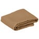 A folded beige cloth table cover.