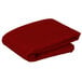 A stack of red folded Intedge square table covers on a white background.