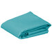 A folded teal rectangular cloth table cover.
