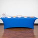 A royal blue Snap Drape spandex table cover on a table with food.