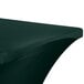 A hunter green Snap Drape contour table cover on a table with a curved edge.