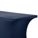 A navy blue Snap Drape spandex table cover on a table.