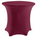 A burgundy Snap Drape Contour table cover on a round table with a white base.