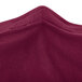 A close up of a burgundy Snap Drape spandex table cover.