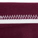 A burgundy spandex table cover with a close-up of the fabric.