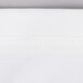 A close up of a white spandex table cover with a white border.