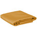 A folded gold table cover on a white background.