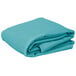 A folded teal rectangular table cover on a white background.