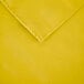 A yellow rectangular cloth table cover with a folded edge.