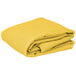 A stack of yellow folded Intedge rectangular table covers on a white background.