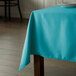 A teal rectangular tablecloth on a table.