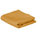 A folded gold rectangular cloth table cover.