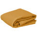 A stack of folded gold rectangular table covers on a white background.