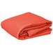 An orange rectangular table cover folded on a white background.