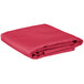 A folded hot pink rectangular table cover.