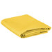 A yellow folded Intedge rectangular cloth table cover.