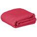 A folded hot pink rectangular table cover.