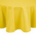 A yellow Intedge round tablecloth on a table.