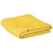 A yellow rectangular cloth table cover folded on a white background.