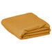 A folded gold rectangular table cover.