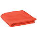 A folded orange table cover on a white background.