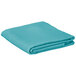 A teal square cloth table cover folded on a white background.